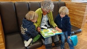 grandmother reading to her grand children